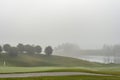 Heavy fog over golf course on early spring morning Royalty Free Stock Photo