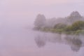 Heavy fog on the river. Trees are visible through thick fog