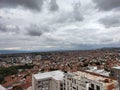 Heavy gray clouds over the dense buildings in a city