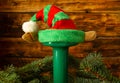 Gym green dumbbell with elf hat and Christmas tree branches. Royalty Free Stock Photo