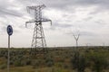 Heavy grey clouds in the cold autumn sky over green fields, trees, forests, streams. Before storm. Electric poles Royalty Free Stock Photo