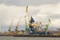 Heavy harbor jib cranes in the Klaipeda Sea Port. Royalty Free Stock Photo