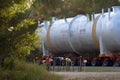 Heavy haulage multi wheeled truck moves a huge refinery vessel through country Victoria to the destination.