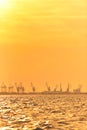 Heavy industrial port equipment, big cranes in sunset light Royalty Free Stock Photo