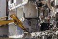 A heavy industrial work machine, digger is destroying an abandoned old building Royalty Free Stock Photo