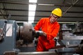 Heavy industrial worker is working on metal work factory, Royalty Free Stock Photo