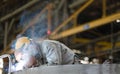 Heavy industry manual worker welding/grinding in a