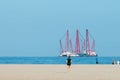 Heavy industry maritime barge off Dutch coastal beach with people in foreground Royalty Free Stock Photo