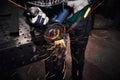 Heavy industry worker cutting steel with an angle grinder Royalty Free Stock Photo