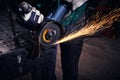 Heavy industry worker cutting steel with an angle grinder Royalty Free Stock Photo