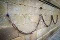 Heavy iron chain hung in the stone walls of the Cathedral of Plasencia, Spain