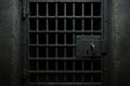 Heavy iron prison gate with barred grate and lock mechanism in dark dungeon setting. concept of security, confinement Royalty Free Stock Photo