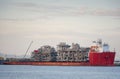 Heavy lift cargo ship barge transporting an oil rig Platform Royalty Free Stock Photo