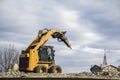 Heavy machinery crushing asphalt for bridge repair