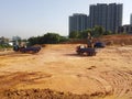 Heavy machinery doing the earthwork site clearing at the construction site.