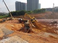 Heavy machinery doing the earthwork site clearing at the construction site.