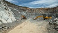 Heavy machinery excavator, hydraulic hammer in a stone quarry Royalty Free Stock Photo