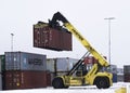 Heavy machinery lifting cargo and shipping containers