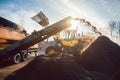 Heavy machinery moving earth and biomass in compost works Royalty Free Stock Photo