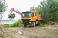 Heavy machinery removing water hyacinth from riverside
