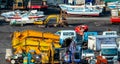 Heavy machinery second hand market. Boat, forklift, agricultural machinery, and electric generator on dirty concrete floor. Royalty Free Stock Photo