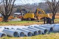 Construction site featuring heavy machinery concrete pipes in infrastructure development Royalty Free Stock Photo