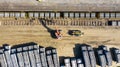 Heavy machines loading concrete railway sleepers on a train