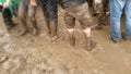 Heavy metal rockers with dirty trousers dancing in the mud on Greenfiels Festival Royalty Free Stock Photo