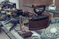 Heavy metallic antique iron and other things on the counter of an antique store Royalty Free Stock Photo