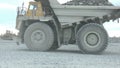 Heavy mining dump trucks moving along the opencast