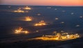 Heavy mining equipment and machines at work in a brown coal open-pit mine at dusk