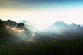 Heavy misty daybreak. Misty daybreak in a beautiful hills. Peaks of hills are sticking out from foggy background.