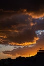 Heavy orange clouds over the city. Last minutes of sunset.