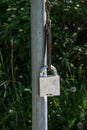 Heavy padlock hanging from a pole.. Royalty Free Stock Photo