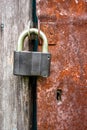 A heavy padlock on a rusty metal door. Royalty Free Stock Photo