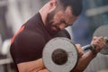 Heavy painful lifting of iron barbell by young strong man with beard great mind motivation and concentration dedication with