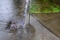 Heavy rain caused flooding in street, water swirling around storm drain Royalty Free Stock Photo