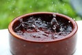 Heavy rain falls In a ceramic bowl filled with water Royalty Free Stock Photo