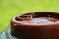 Heavy rain falls In a ceramic bowl filled with water Royalty Free Stock Photo