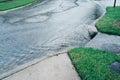 Heavy rain flowing through sewer drain.