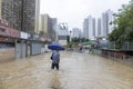 After heavy rain in Hong Kong, citizens walk in muddy water on the flooded street of Lung Cheung Road in Wong Tai Sin.