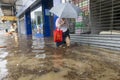 After heavy rain in Hong Kong, citizens walk in muddy water on the flooded street of Lung Cheung Road in Wong Tai Sin.