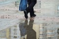 Heavy rain, large puddles on the sidewalk, on the puddles stomping feet of passers-by.