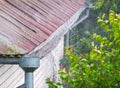 Heavy rain. Rainwater pouring out of old downspout Royalty Free Stock Photo