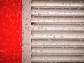 heavy rain on a red walled industrial building with grey shutters