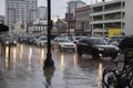 Heavy rain storm in downtown Ottawa, cars driving on the street thru deep puddles of water.