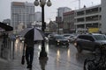 Heavy rain storm in downtown Ottawa, cars driving on the street thru deep puddles of water.