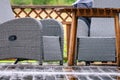 Heavy rain at wooden terrace with summer chairs, wooden table. Blurry green forest at background. Everything is very wet. Royalty Free Stock Photo