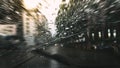 Heavy raindrops on the windshield glass.