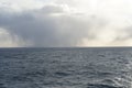 Heavy rainfall clouds bringing abundant rainfall and atmospheric precipitation observed on Pacific ocean near Aleutian Islands. Royalty Free Stock Photo